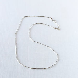 Rhythms Necklace, vintage brass beads in segments on silk cord with 14K gold-filled extender. Choose length and metal. This necklace is great layered or on its own. Sterling pictured